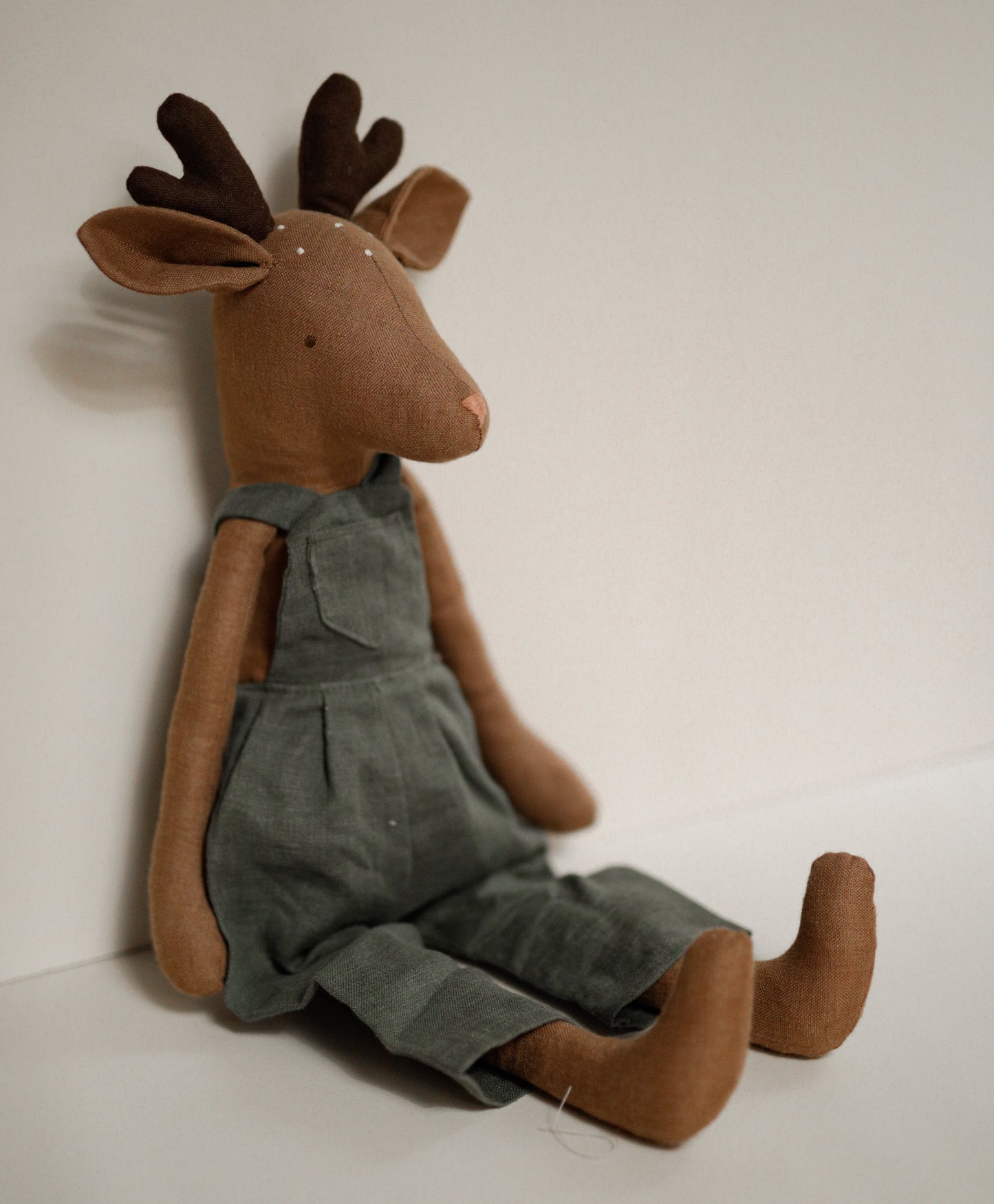 Deer toy 55 cm in green linen dungarees with antlers