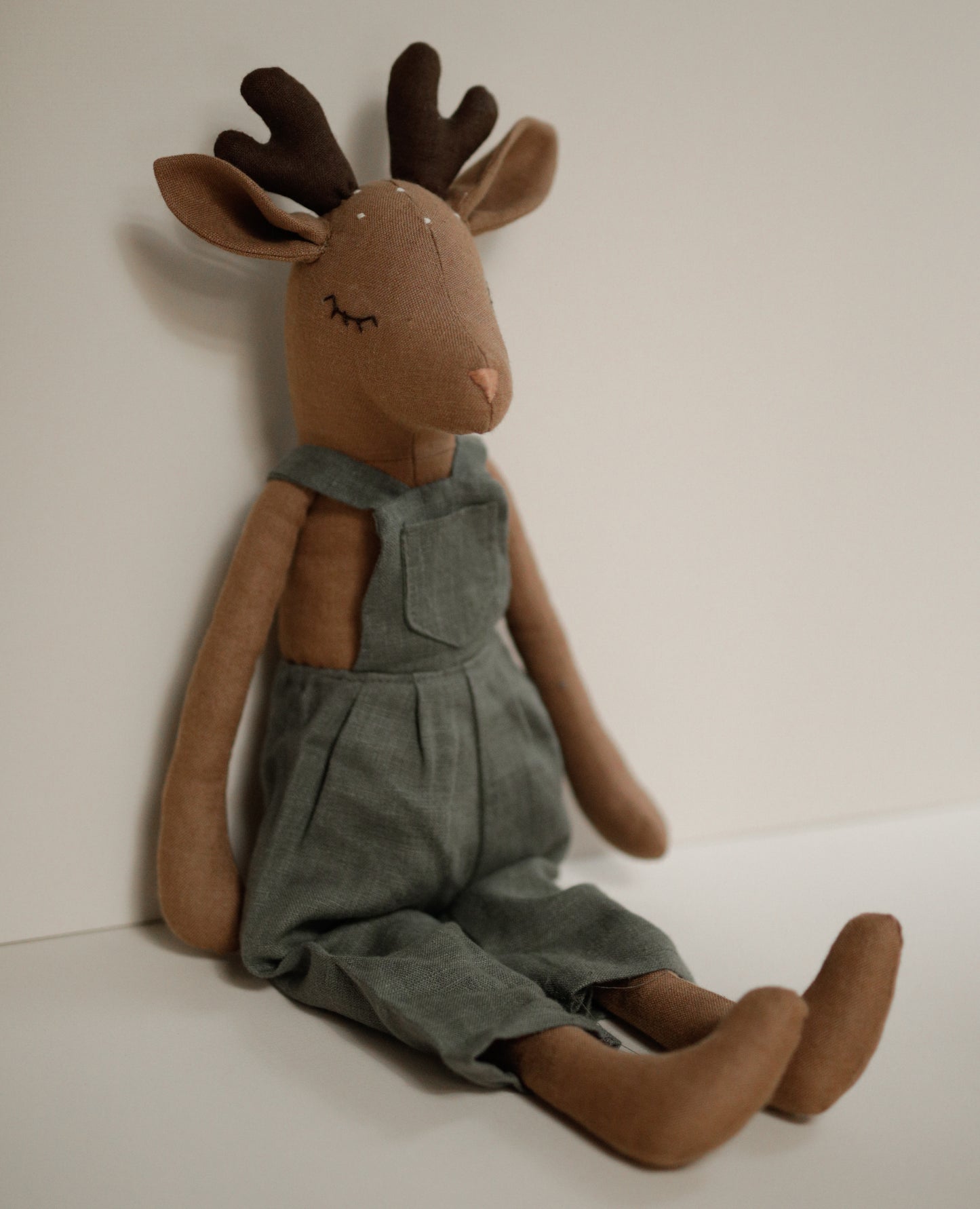 Deer toy 55 cm in green linen dungarees with antlers