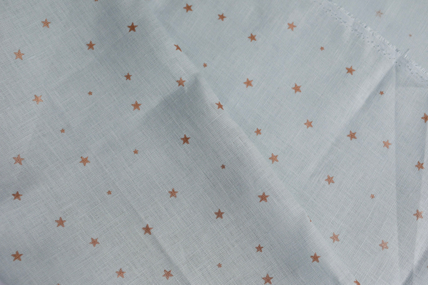 548 Copper stars on light blue 100% linen fabric