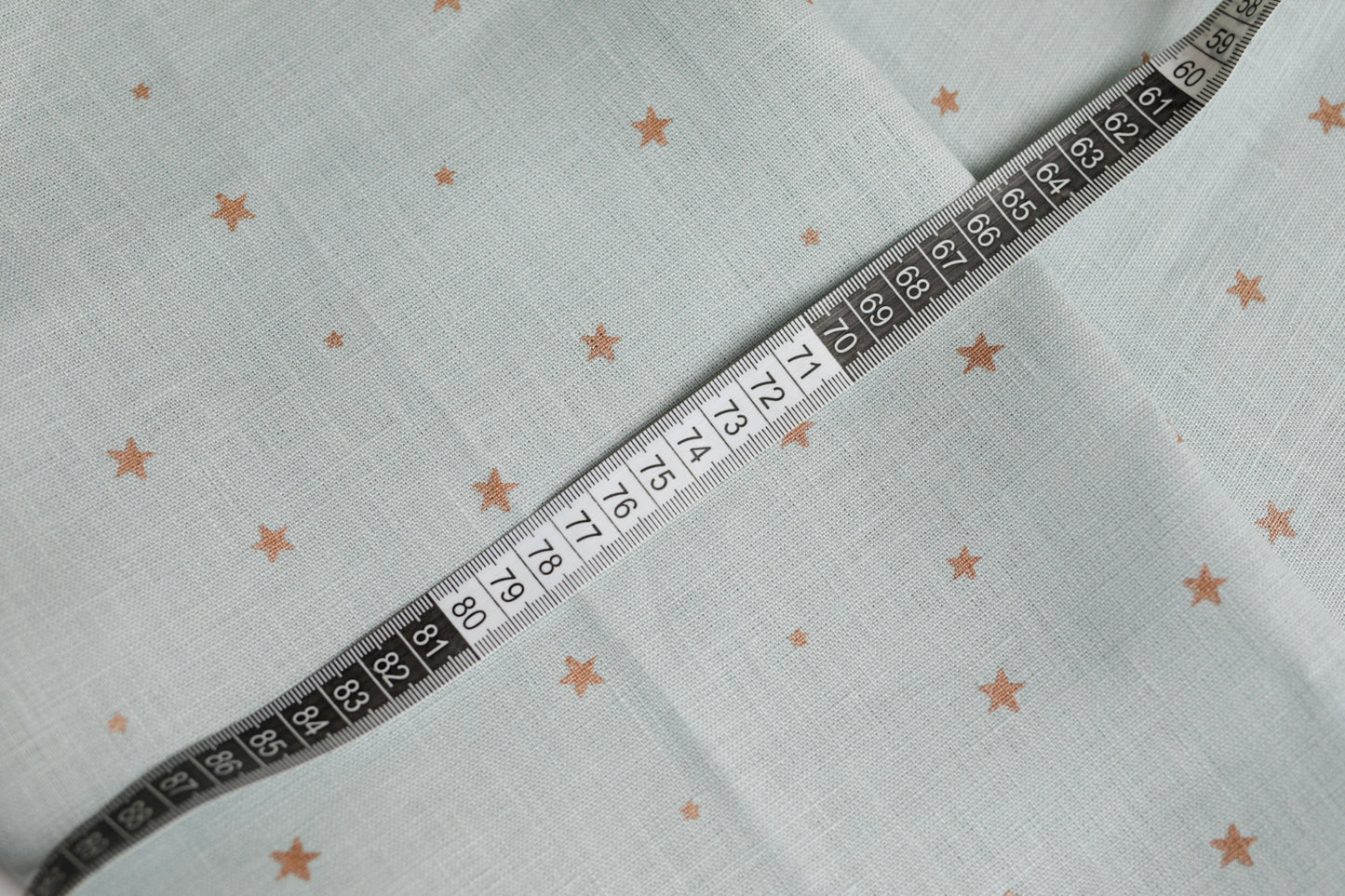 548 Copper stars on light blue 100% linen fabric