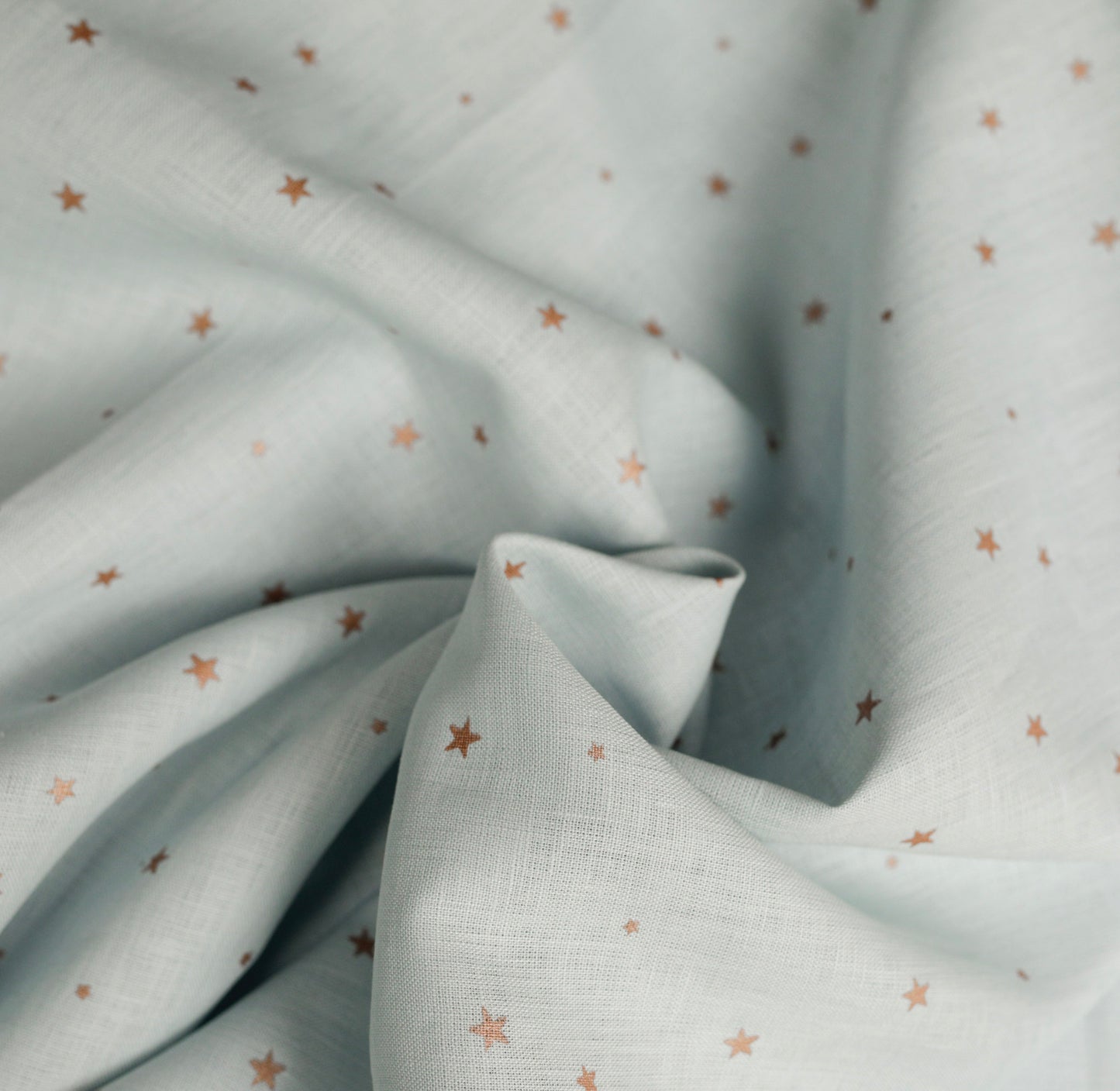 548 Copper stars on light blue 100% linen fabric