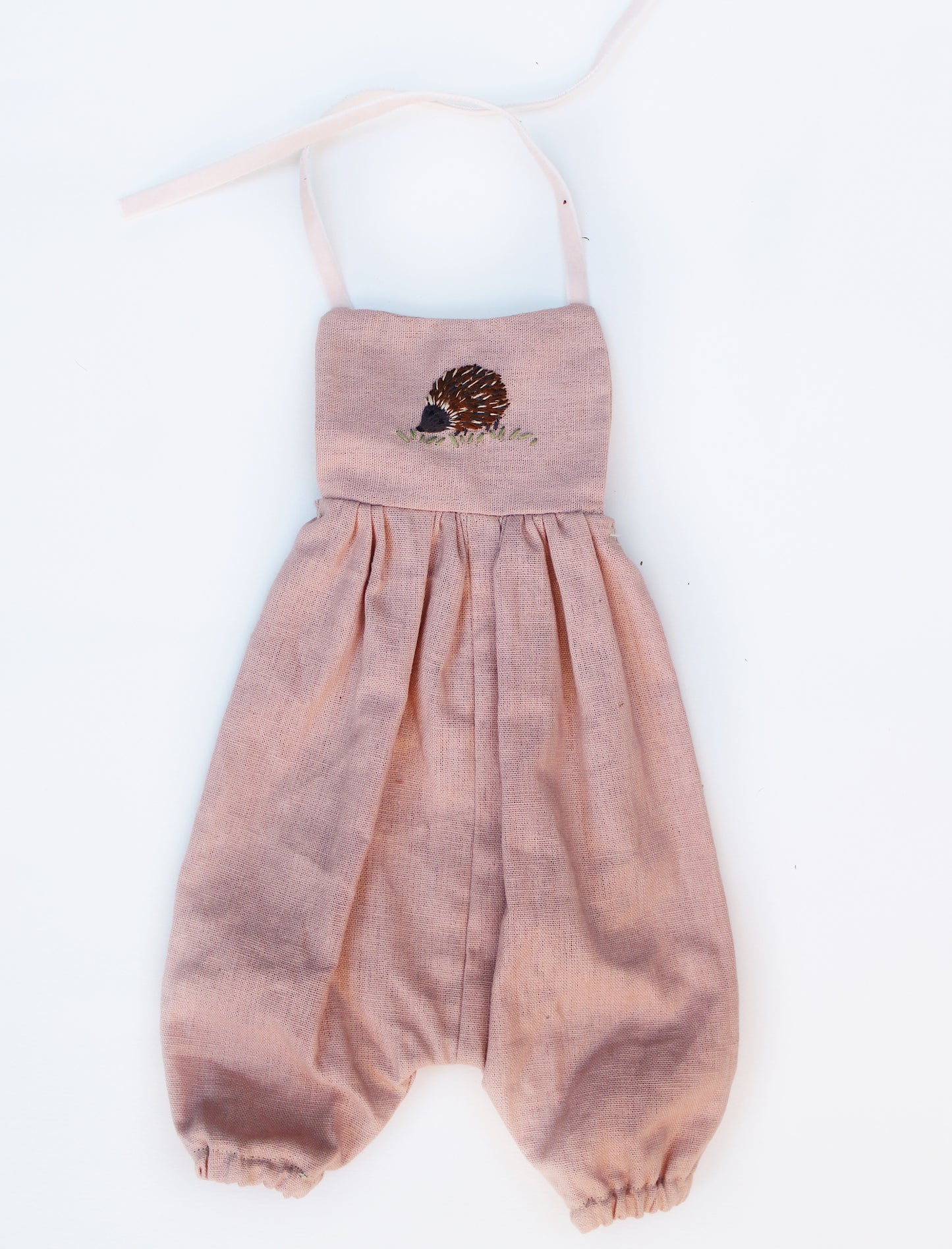 Pink linen romper with hedgehog embroidery